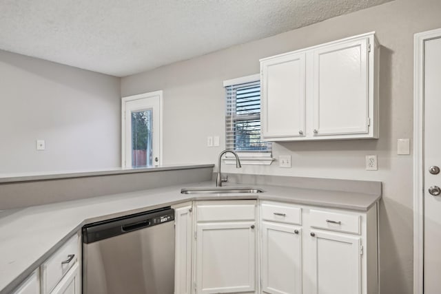 kitchen featuring sink, white cabinetry, dishwasher, and a textured ceiling