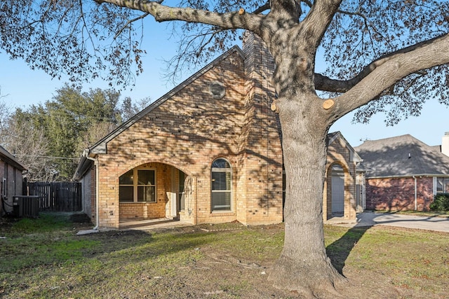 view of front of home with a front yard and central air condition unit