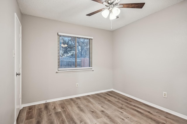 unfurnished room with a textured ceiling, ceiling fan, and wood-type flooring