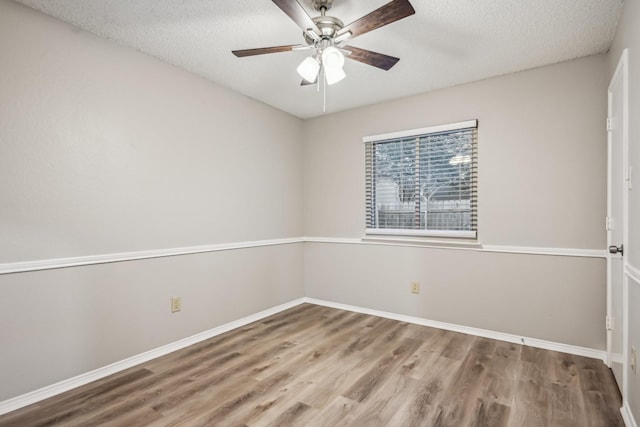 unfurnished room with ceiling fan, a textured ceiling, and hardwood / wood-style flooring