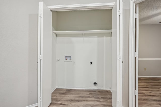 washroom featuring hookup for a washing machine, a textured ceiling, hardwood / wood-style floors, and hookup for an electric dryer