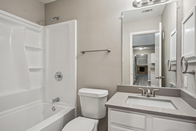 full bathroom with toilet, vanity, and shower / tub combination