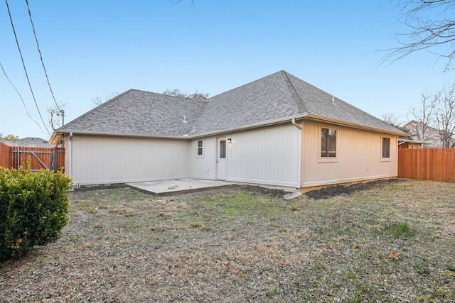 rear view of house featuring a patio area and a lawn