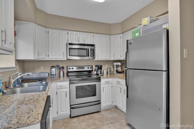 kitchen with sink, white cabinets, and stainless steel appliances