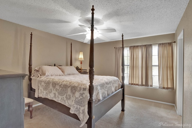 carpeted bedroom featuring ceiling fan and a textured ceiling