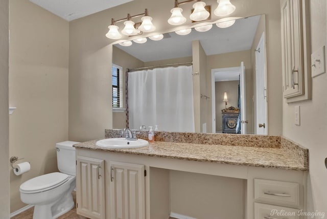 bathroom featuring toilet and vanity