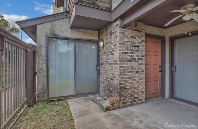 entrance to property with ceiling fan