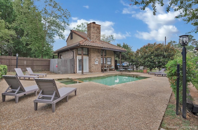 view of swimming pool featuring an in ground hot tub and a patio