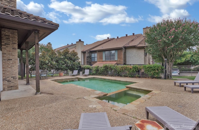 view of pool with an in ground hot tub and a patio area