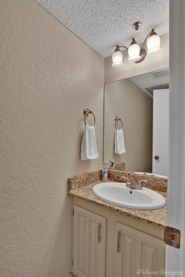 bathroom with vanity and a textured ceiling