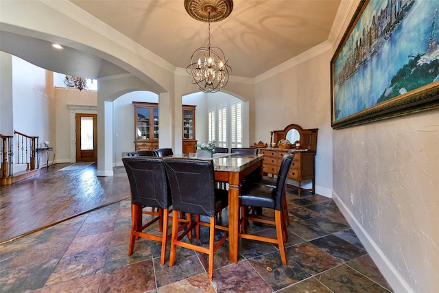 dining room featuring ornamental molding, a wealth of natural light, and an inviting chandelier