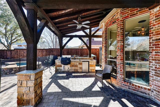 view of patio with area for grilling and ceiling fan