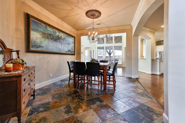 dining space featuring an inviting chandelier and ornamental molding