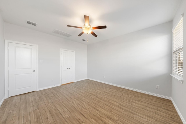 unfurnished room with ceiling fan and light wood-type flooring