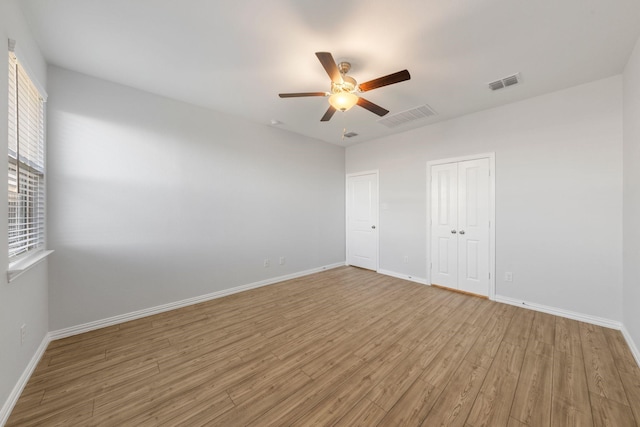 empty room featuring ceiling fan and wood-type flooring