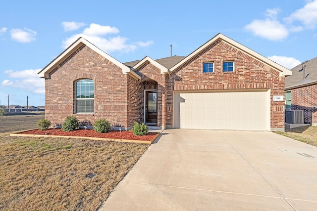 view of property featuring a front yard, a garage, and cooling unit