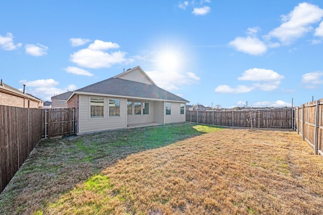 back of house featuring a yard