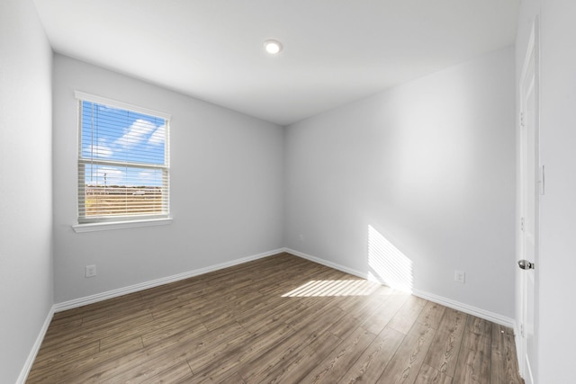 unfurnished room with hardwood / wood-style floors