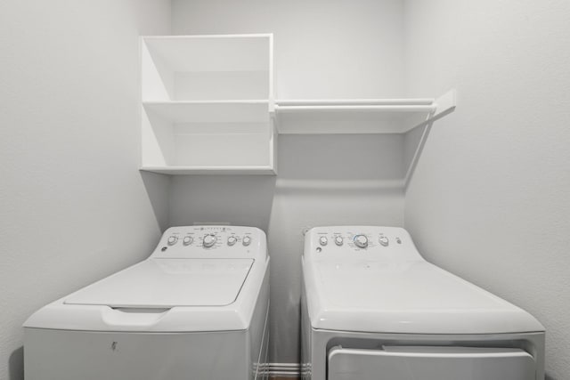 washroom with washing machine and clothes dryer