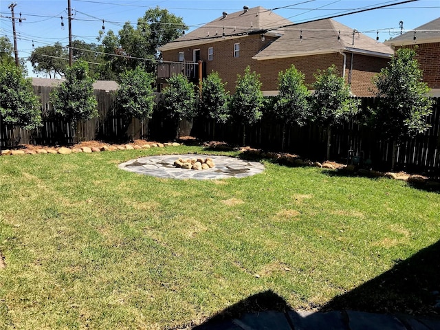 view of yard with an outdoor fire pit