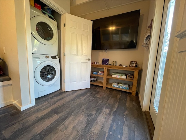 washroom featuring stacked washer / drying machine and dark wood-type flooring