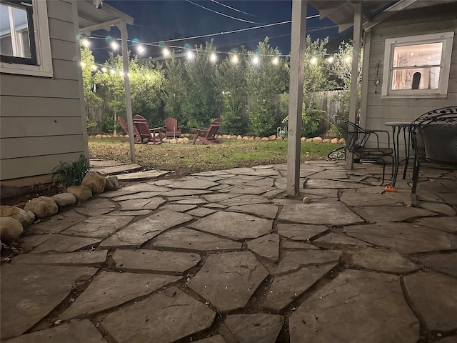 patio at twilight featuring a fire pit