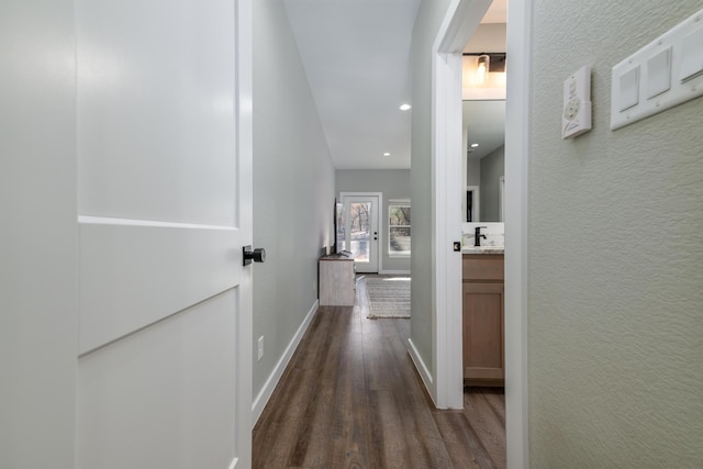 hallway featuring dark hardwood / wood-style flooring and sink