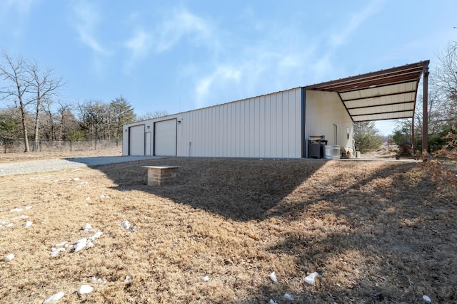 view of outbuilding with a garage and a carport