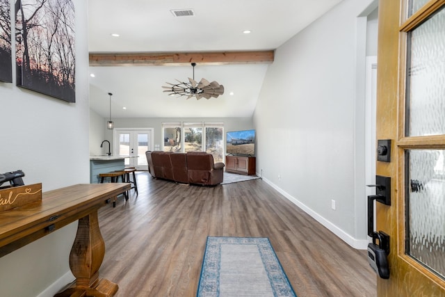 interior space featuring lofted ceiling with beams, hardwood / wood-style floors, and french doors