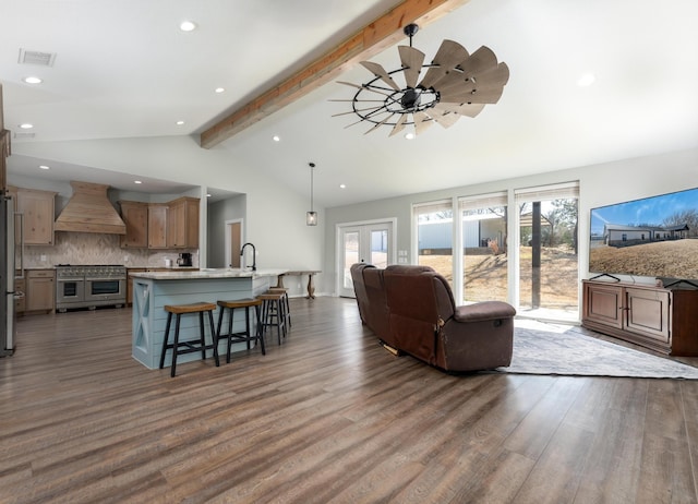 living room featuring sink, dark hardwood / wood-style floors, vaulted ceiling with beams, and french doors