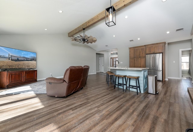 living room with lofted ceiling with beams, dark wood-type flooring, and sink