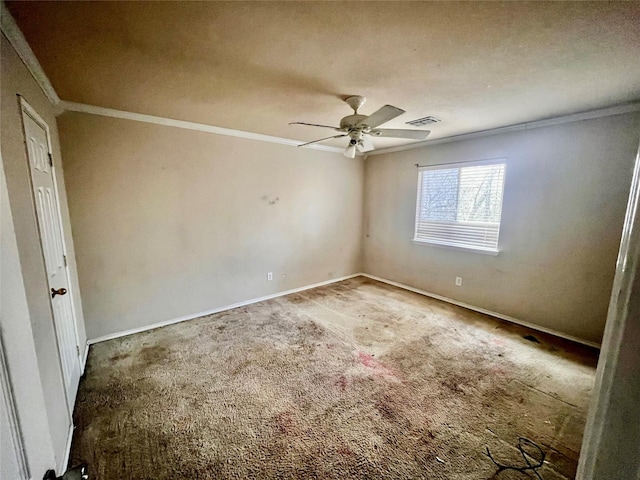 carpeted spare room with ceiling fan and crown molding