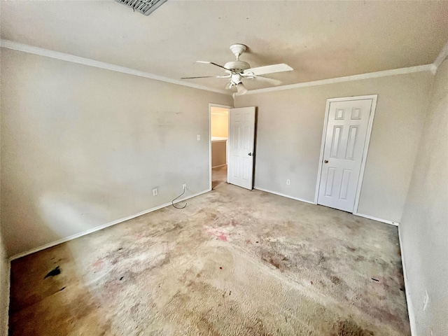 unfurnished bedroom with ceiling fan, carpet flooring, and crown molding