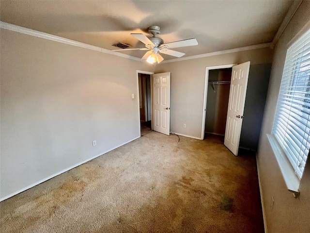 unfurnished bedroom featuring ceiling fan, a closet, light colored carpet, and crown molding