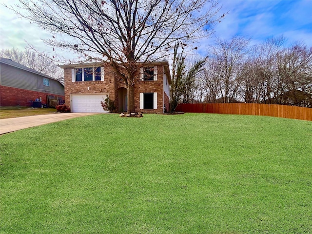 view of front of home with a front yard and a garage