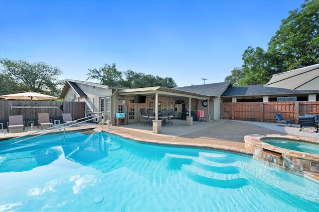 view of swimming pool featuring an in ground hot tub and a patio