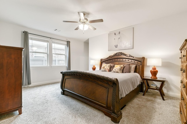 bedroom featuring ceiling fan and light carpet