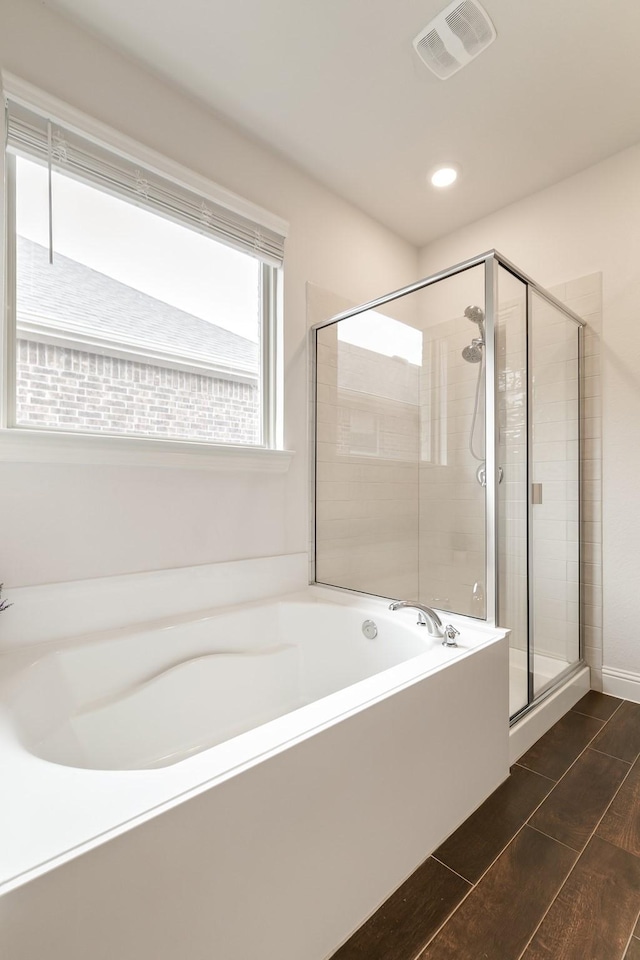 bathroom featuring separate shower and tub