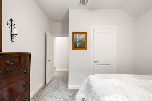 carpeted bedroom with lofted ceiling