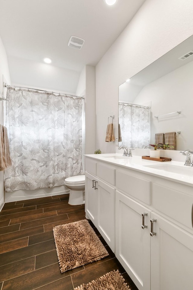 full bathroom featuring toilet, shower / tub combo, and vanity