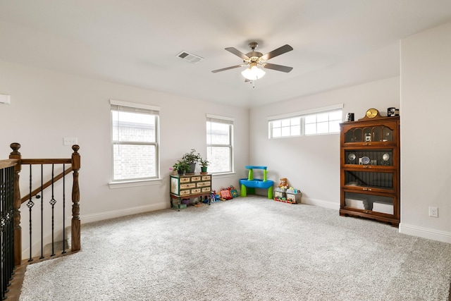 rec room with ceiling fan, carpet, and a wealth of natural light