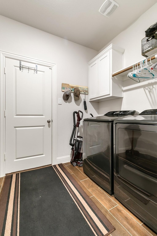 laundry area featuring cabinets and washer and dryer