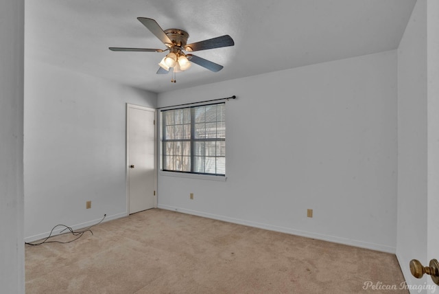 spare room featuring light carpet and ceiling fan