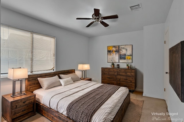 bedroom with ceiling fan and light colored carpet