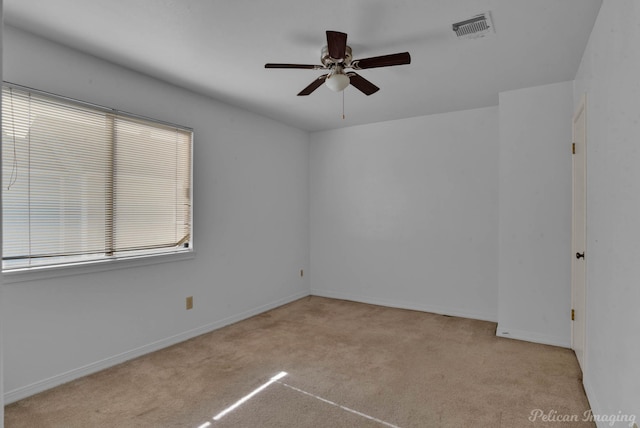 carpeted empty room featuring ceiling fan