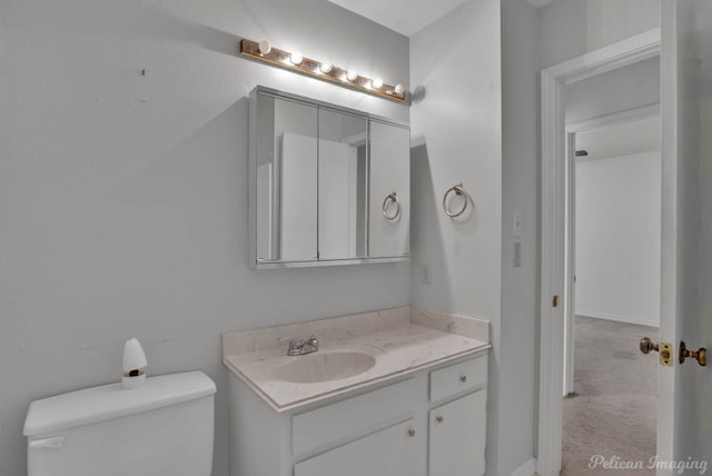 bathroom featuring toilet and vanity