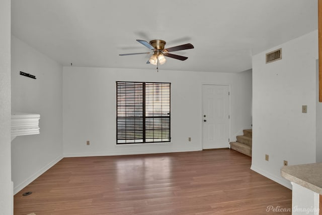 empty room featuring ceiling fan and light hardwood / wood-style flooring