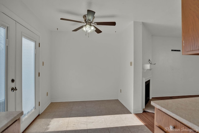 interior space featuring ceiling fan and light tile patterned floors