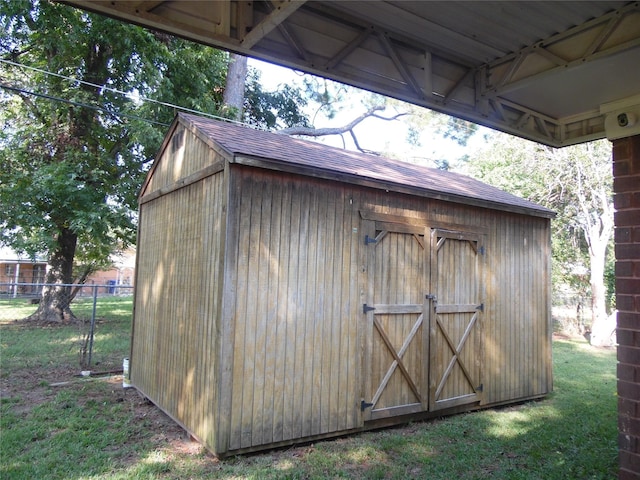 view of outbuilding with a yard