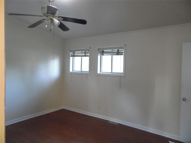 unfurnished room with ceiling fan and dark hardwood / wood-style flooring